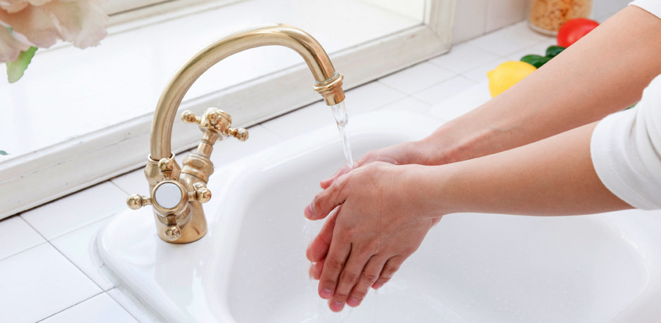 gold kitchen tap, person washing their hands