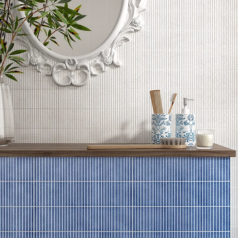 Blue tiled ledge behind a bathroom basin, creating a practical surface for toiletries and everyday essentials