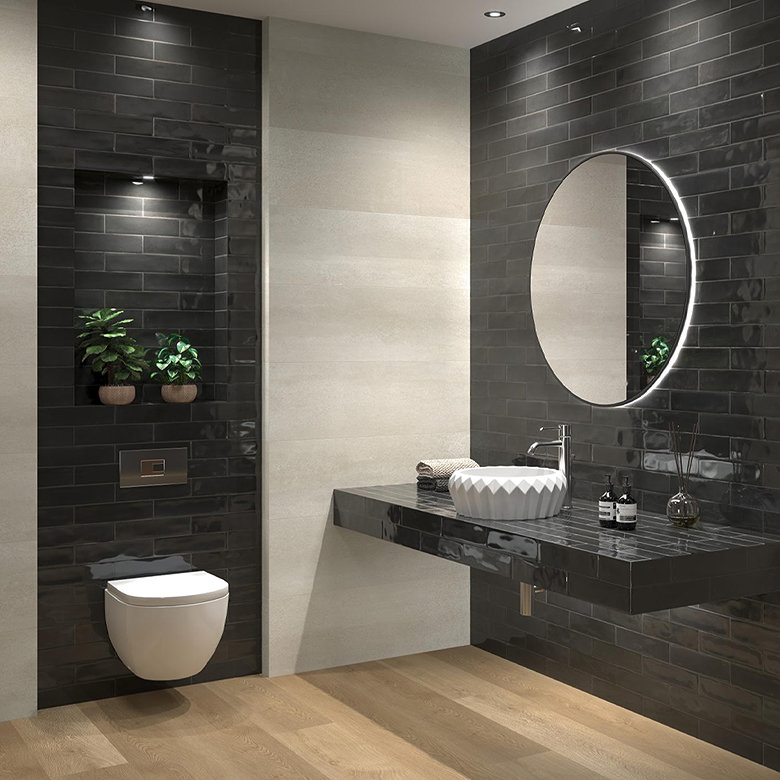 Modern bathroom with glossy black metro tiles used across the walls, recessed shelf and floating basin countertop