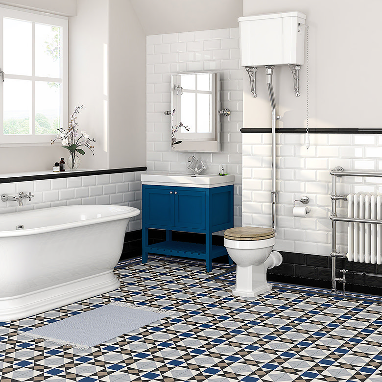 Victorian-style bathroom with white metro wall tiles and blue, black and white geometric patterned floor tiles