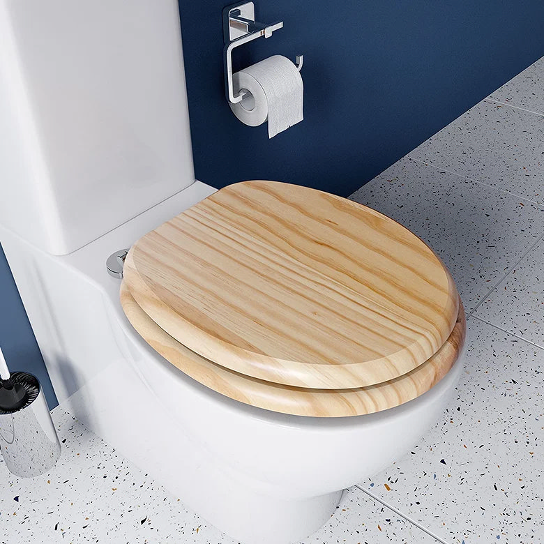 white toilet with light pine wood toilet seat