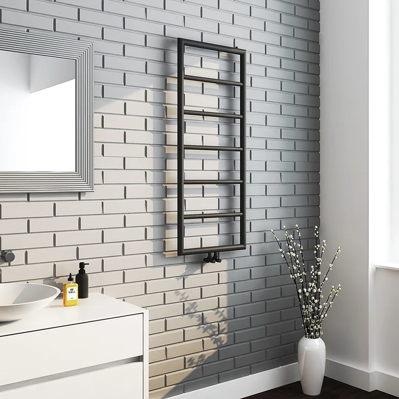 black heated towel rail on white tiles