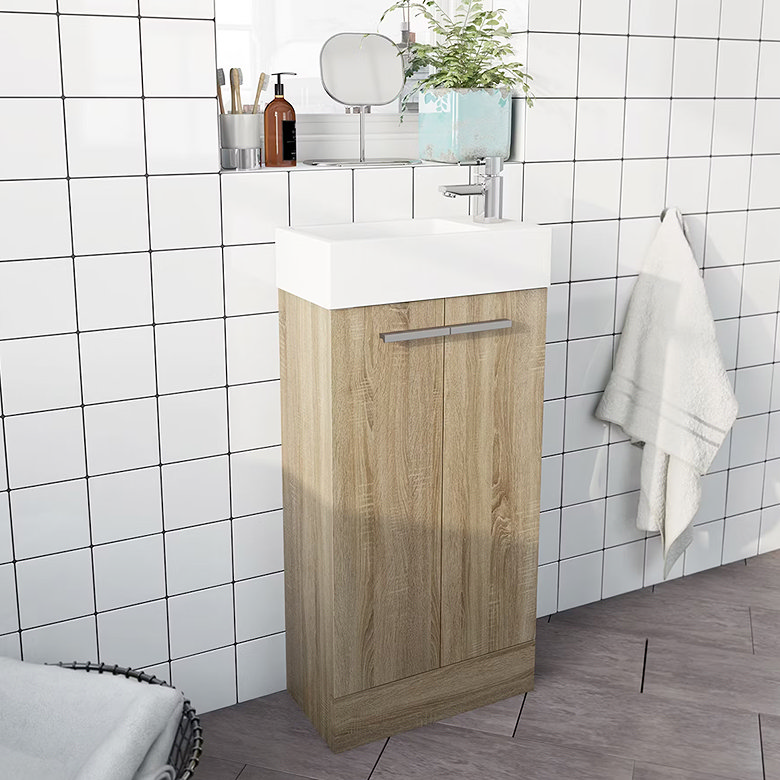 compact, light wood vanity unit and white basin