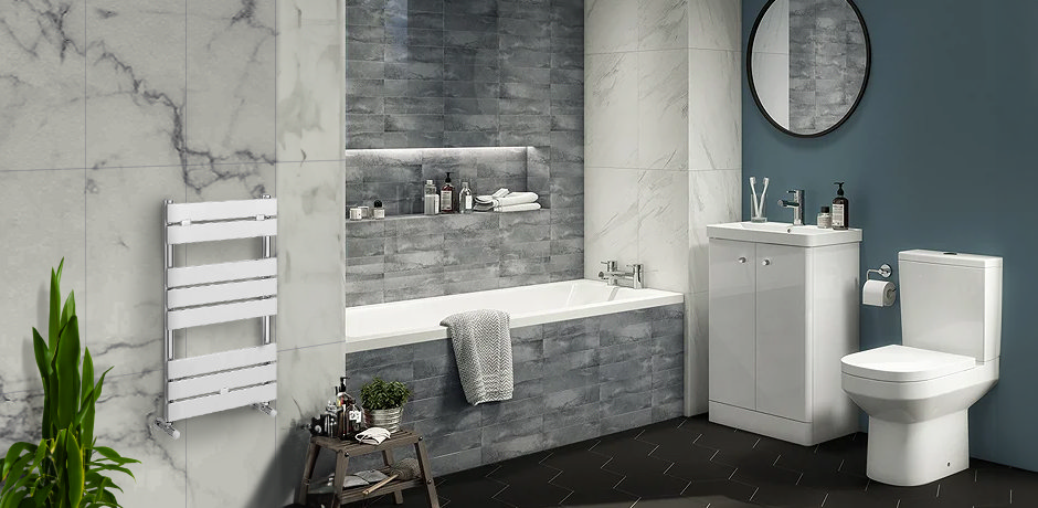 grey tiled bath panel, with white bathroom suite and dark flooring