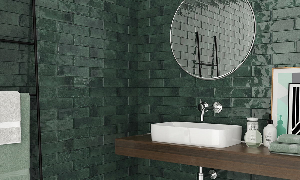dark green, rustic tiles with brown vanity and white sink, dark grout