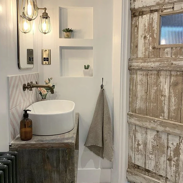 Wooden door with white wall and countertop basin, on a wooden vanity