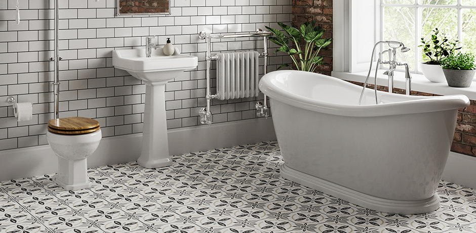  grey tiled bathroom with freestanding bathtub and toilet and basin suite
