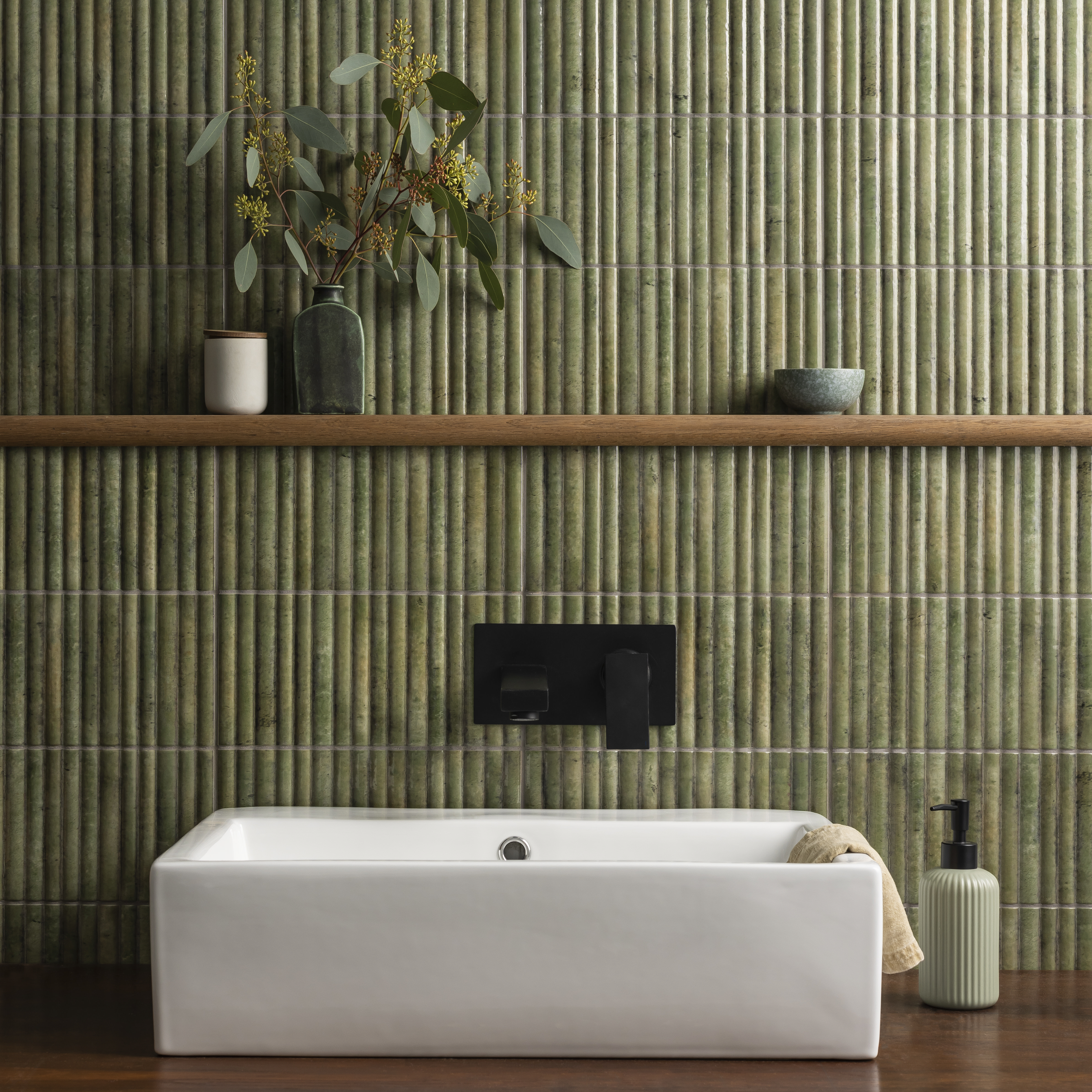green fluted tiles with white countertop basin