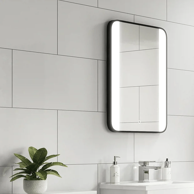 White wall tiles with black mirror white basin and small plant