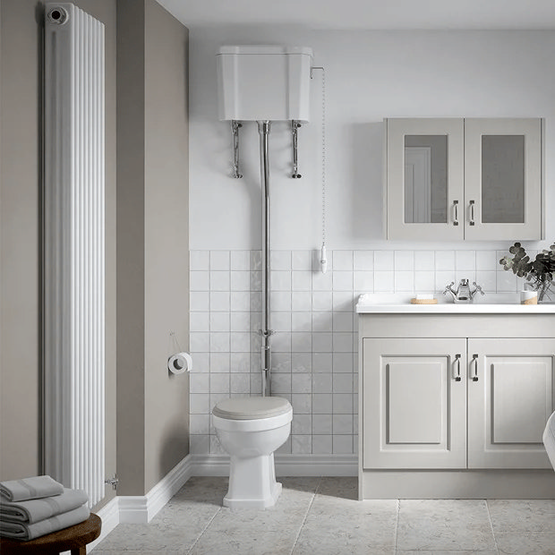 Traditional high level toilet in white bathroom
