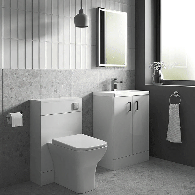 White bathroom suite with light grey tiles