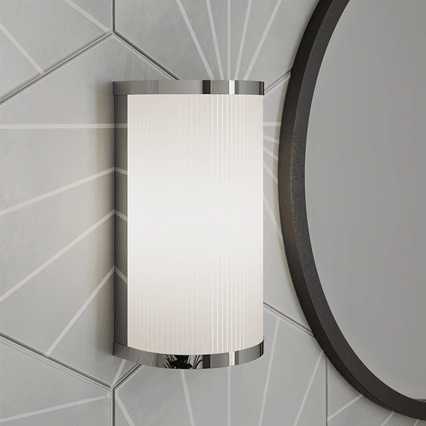 Chrome fluted wall light on grey tiled wall