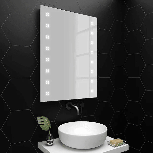 Illuminated mirror on black tiles wall with countertop basin