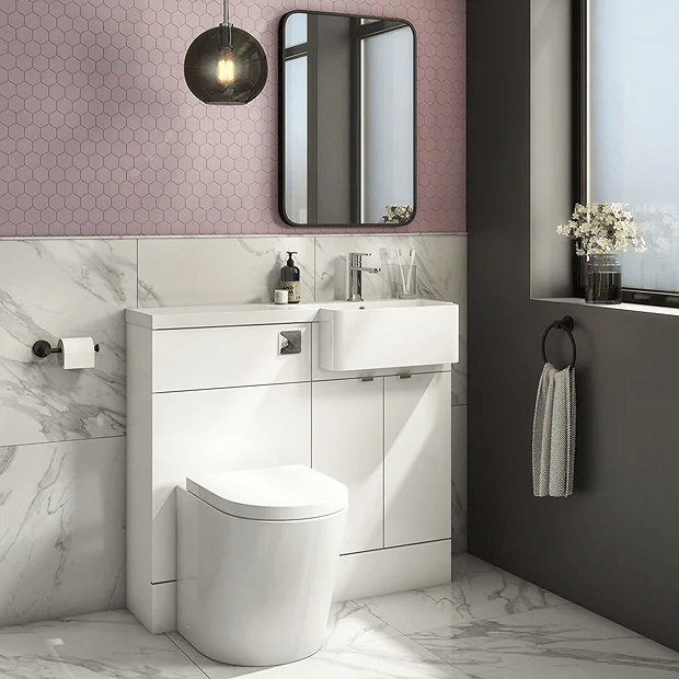 Modern white bathroom with pink tiles and white combination unit