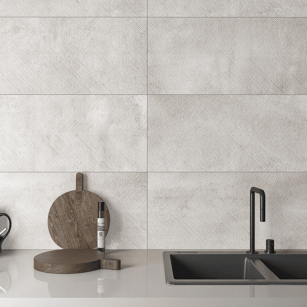 White stone tiles in kitchen with dark grey sink