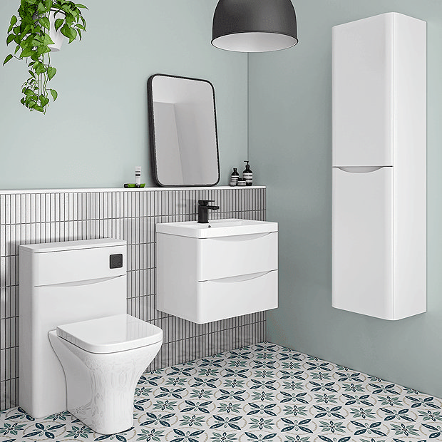 White bathroom furniture with blue and white tiles and mint green walls