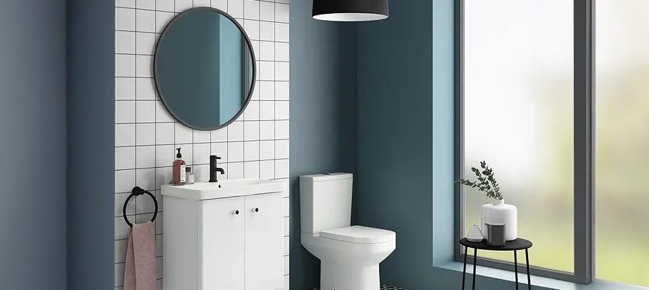 White bathroom suite with white tiles and blue walls