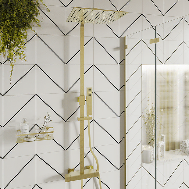 Gold shower on black and white geometric tiles and hanging plant