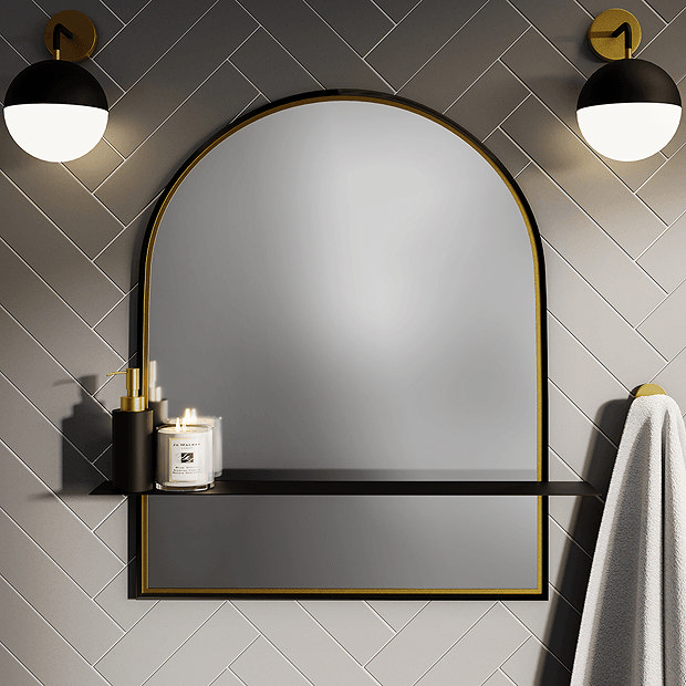 Black and gold arched mirror with black shelf and wall lights