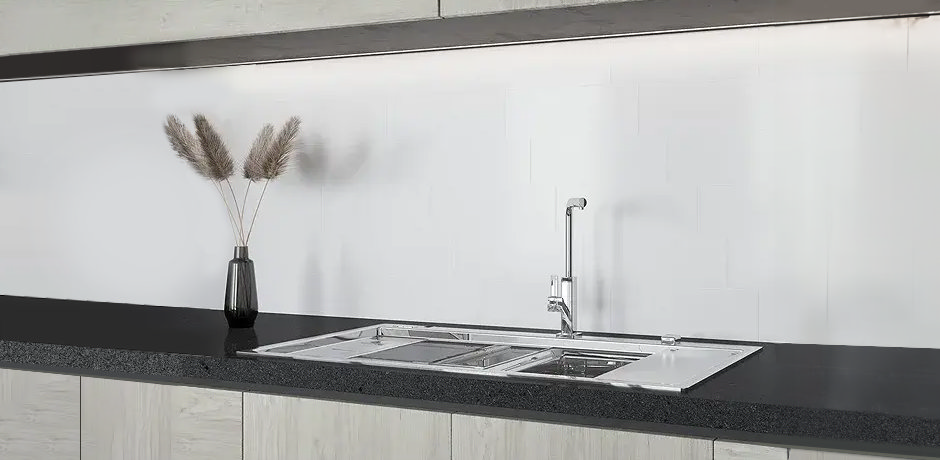 White wall tiles in kitchen with stainless steel sink 