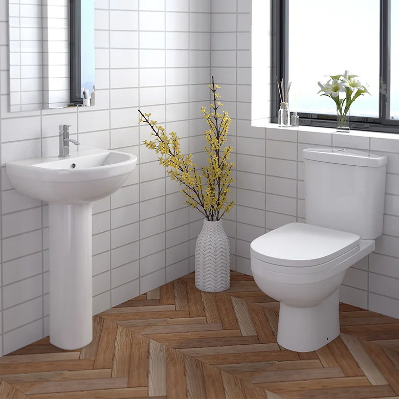 modern downstairs bathroom with toilet and pedestal sink