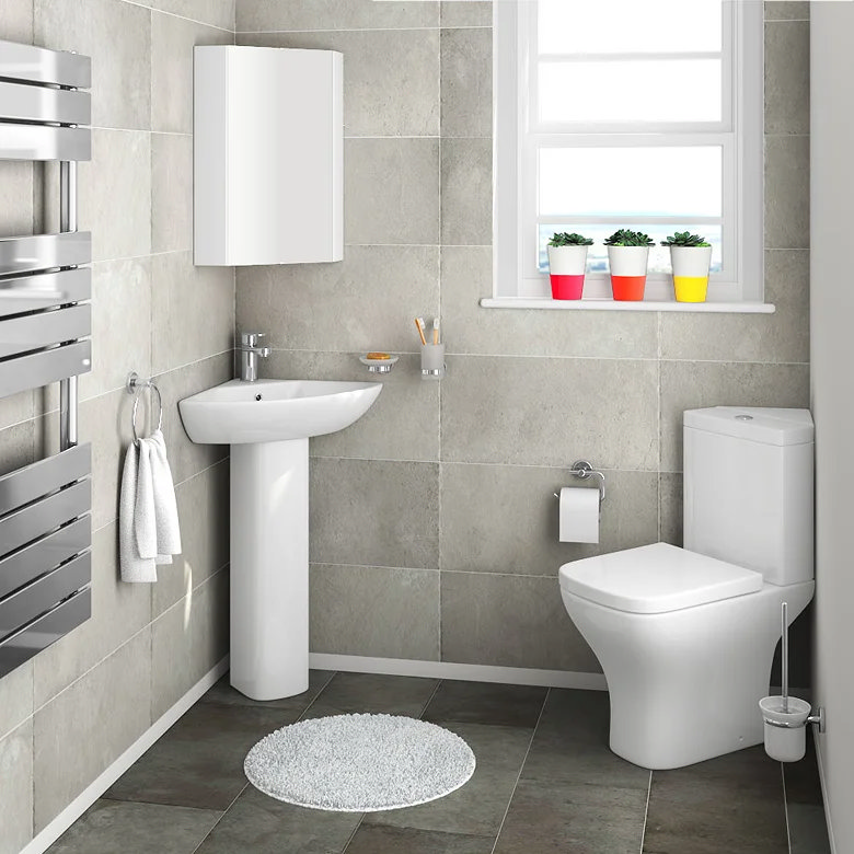 corner pedestal sink and toilet in downstairs bathroom