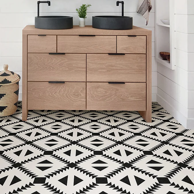 bathroom vanity with black and white patterned adhesive floor tiles