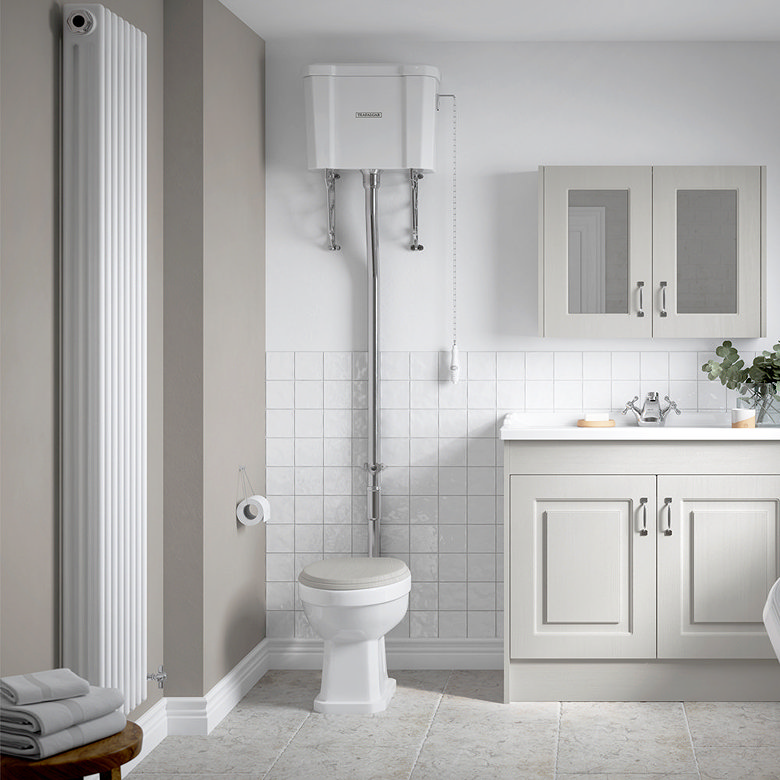 traditional high level toilet with pull chain cistern and chrome flush pipe in classic bathroom
