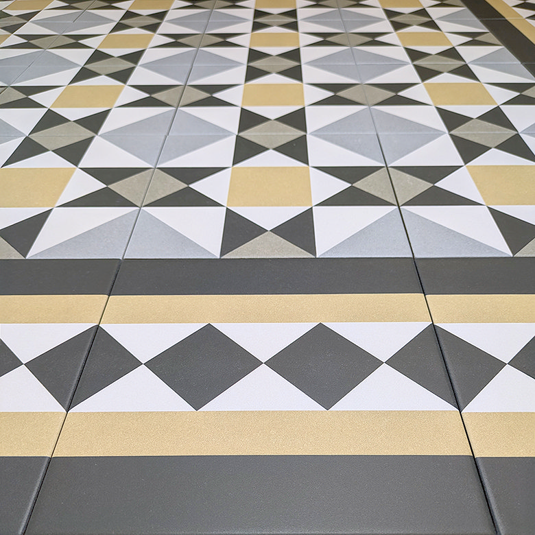 Geometric tile design featuring a pattern of black, white, and gold diamonds and stripes, ideal for modern and vintage-inspired bathroom and kitchen floors.