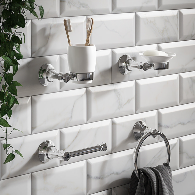 chrome bathroom accessories set with tumbler holder, soap dish and towel rail on marble effect wall tiles