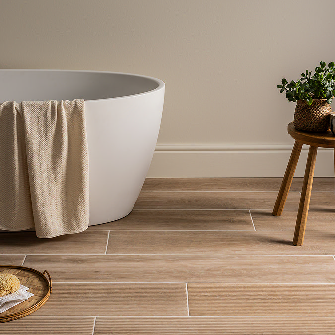 modern bathroom with freestanding bath, wood effect floor tiles and neutral styling