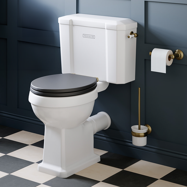 close coupled toilet with wall mounted cistern and black seat in traditional bathroom with checkerboard floor