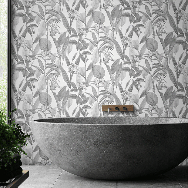 Grey and white wallpaper behind grey stone bath