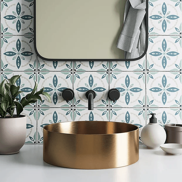 Blue and white traditional tiles with black mirror, black wall mounted tap and gold basin