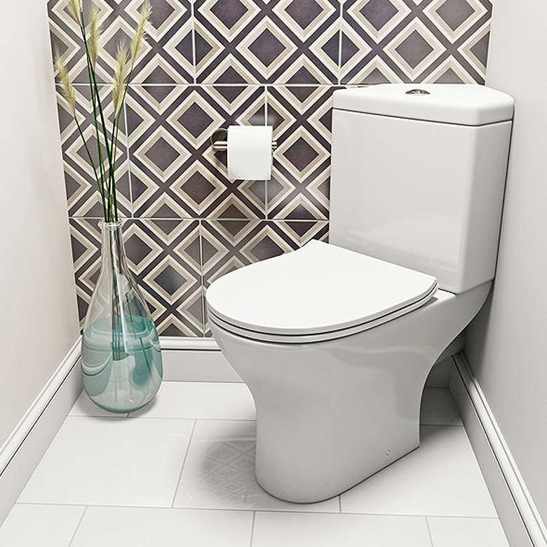 white corner toilet in small en suite bathroom