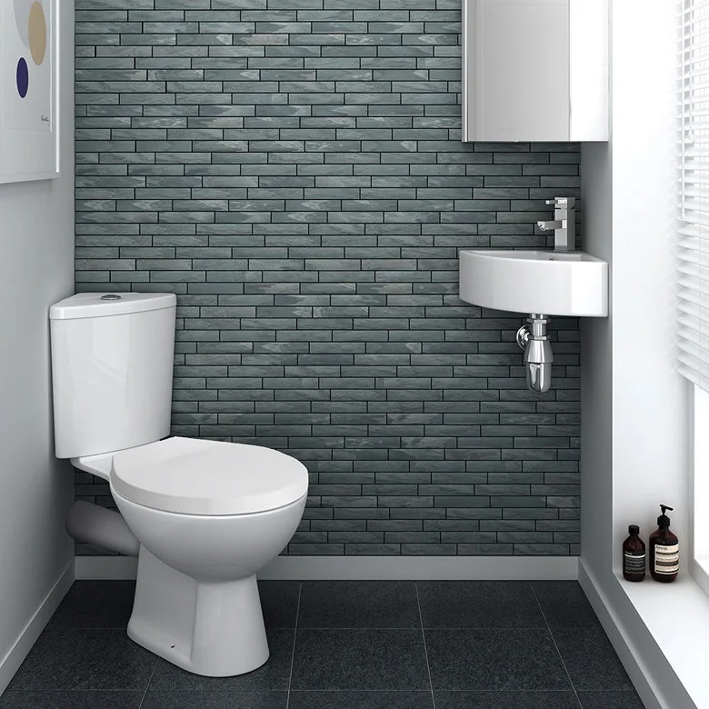 small cove bathroom with corner toilet and basin