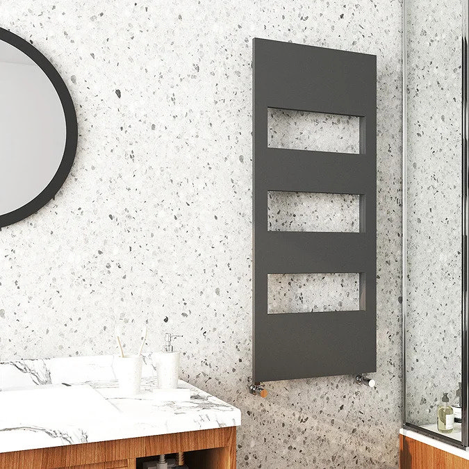 anthracite cut-out towel rail on light speckled stone wall
