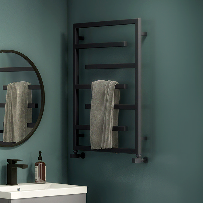 geometric anthracite towel rail against dark blue wall