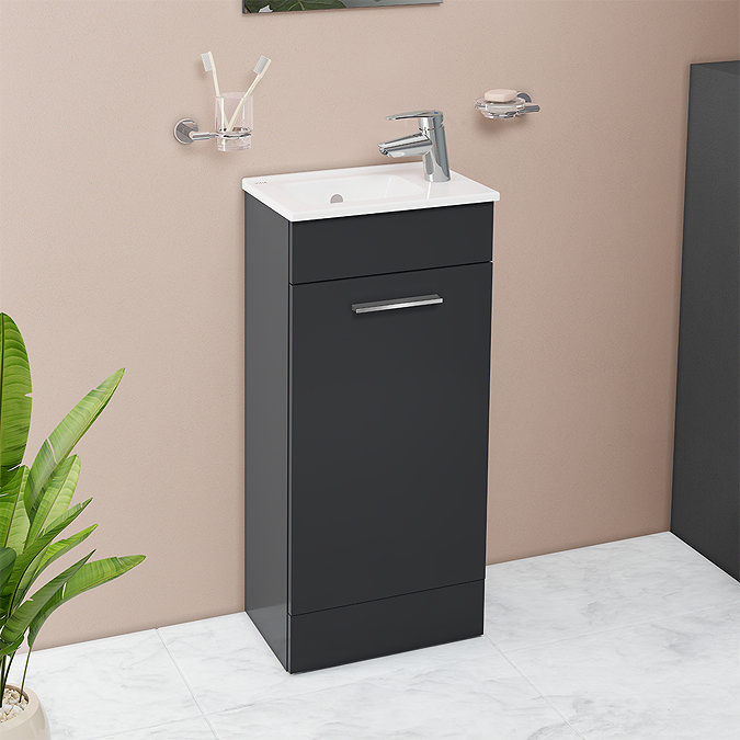 small anthracite standing vanity unit against beige wall and marble floor