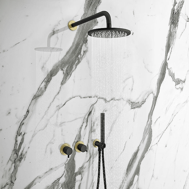 Black and brass shower on marble wall