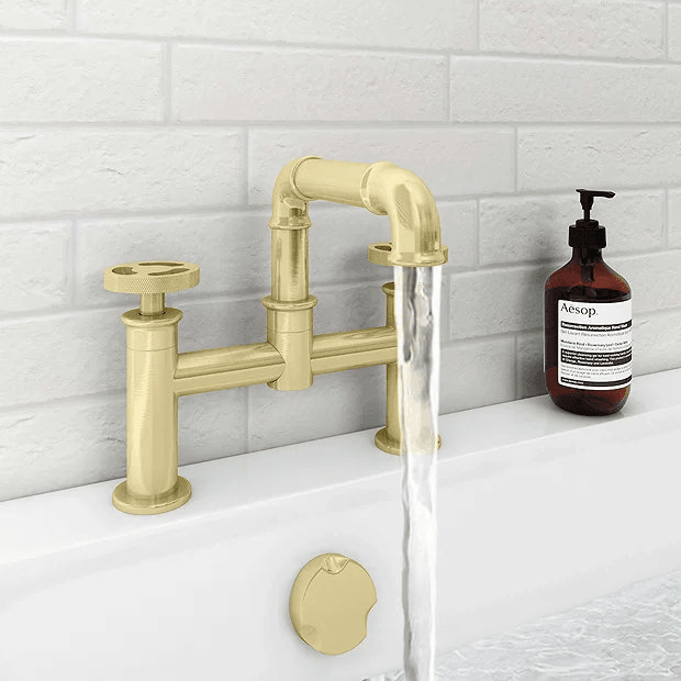 Industrial brass bath tap with white brick tiles