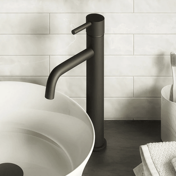 black basin tap with white basin and tiles