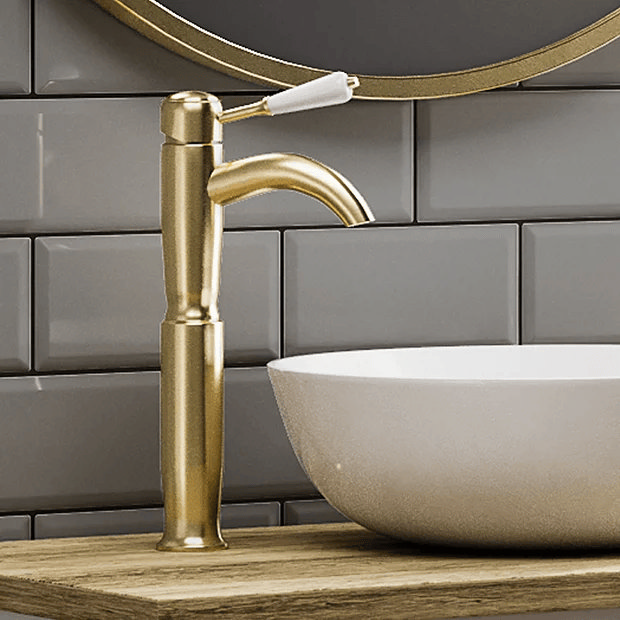 Traditional brass tap with white basin and subway tiles