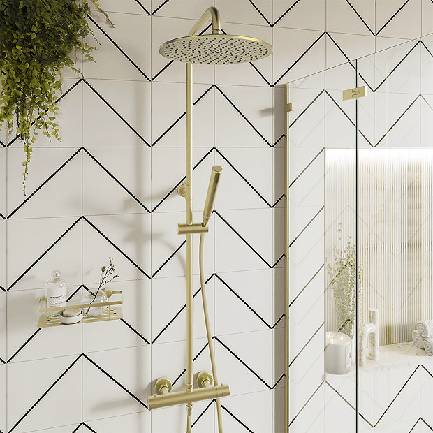 Brass shower on cream and black geometric tiles