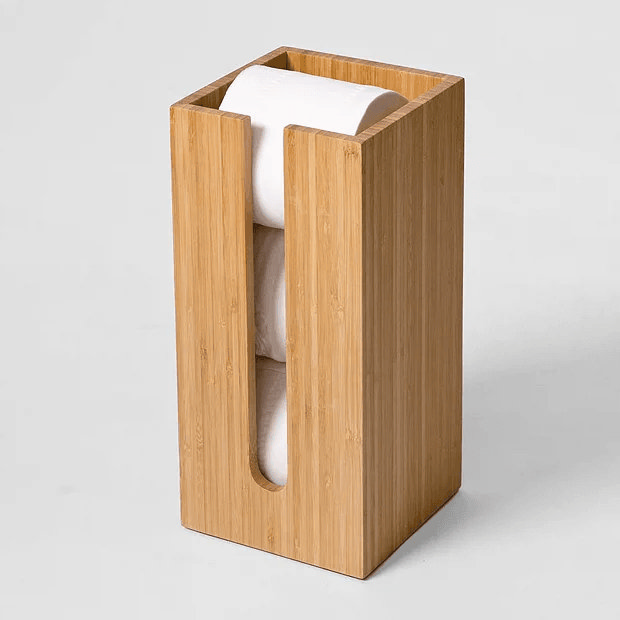 Wooden toilet roll storage box in white room