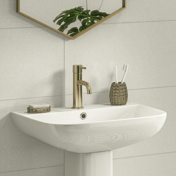 Brass tap on white basin with white wall tiles