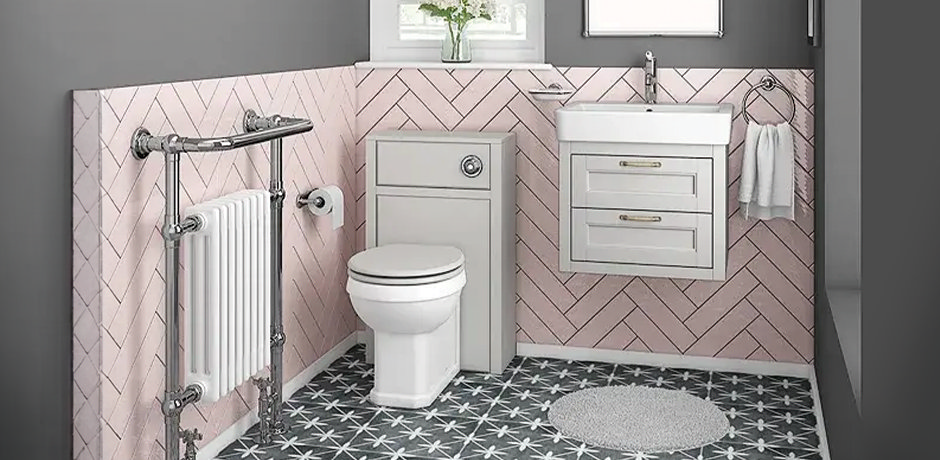 small bathroom with pink tiles and grey furniture