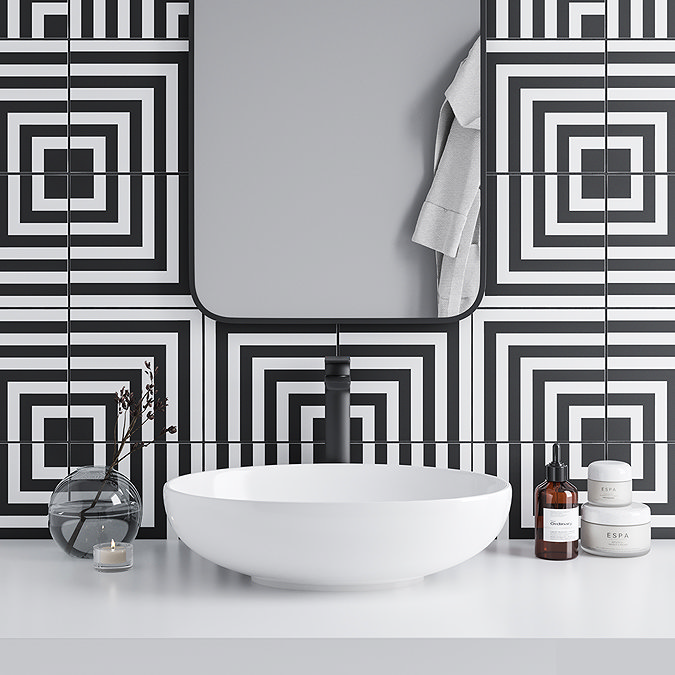 Black and white modern tiles behind basin