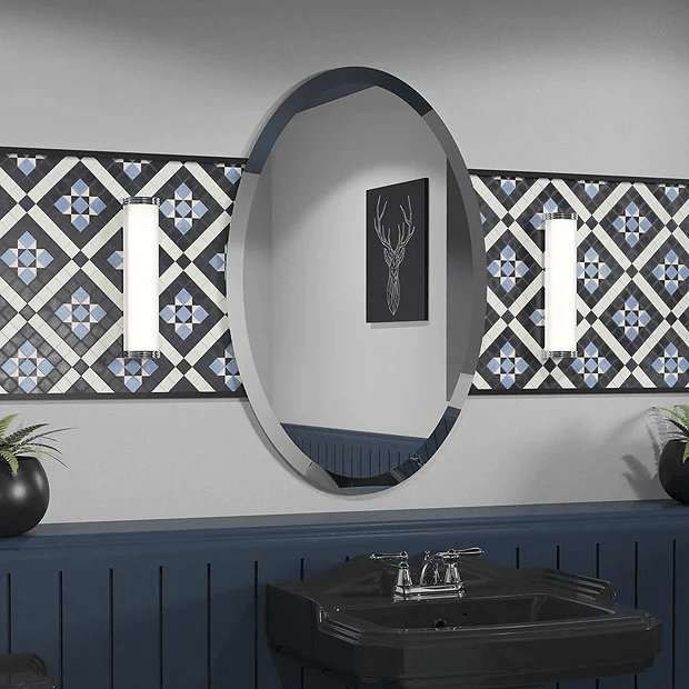 Oval Mirror on blue and white tiled wall 