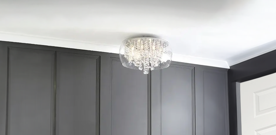 Chrome light fixture in grey room with white table 